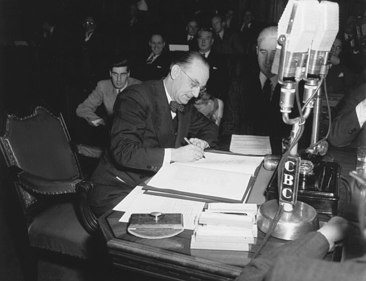 Joey Smallwood signing the Terms of Union admitting Newfoundland into Canadian Confederation, December 11, 1948